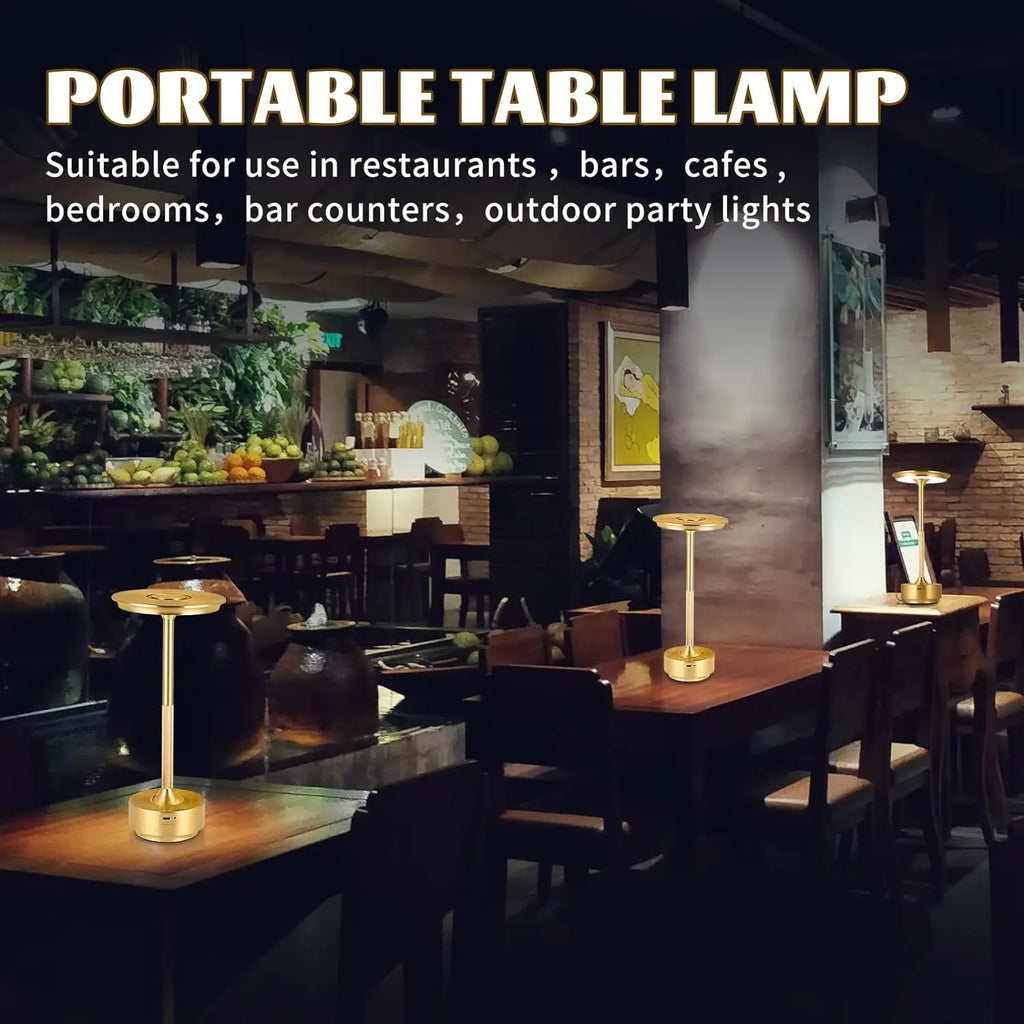 Golden portable table lamp with tall stem and round base on restaurant table