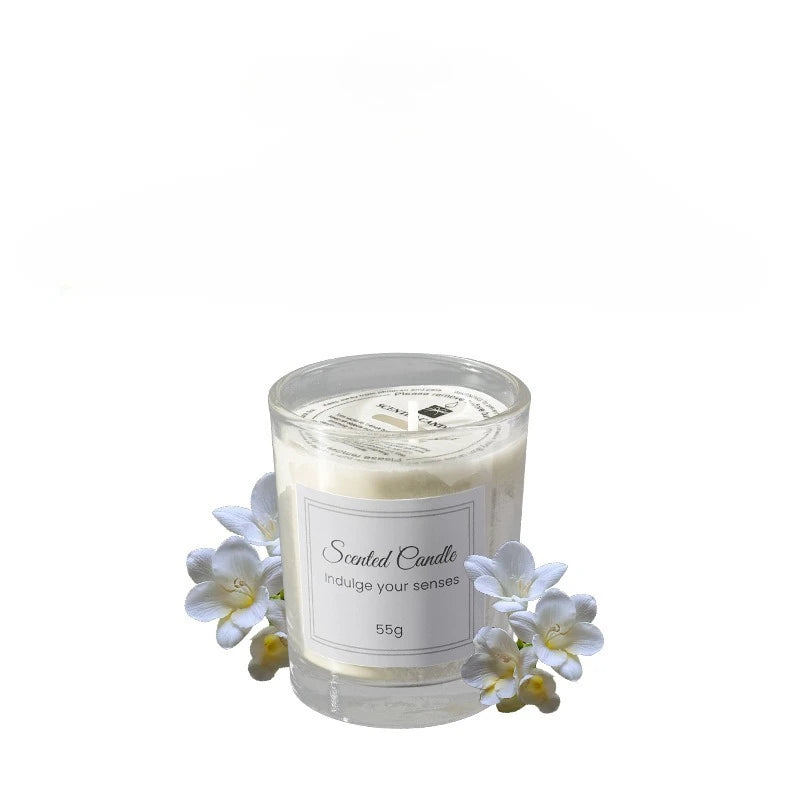 Scented candle in clear glass with white blossoms, 55g label.