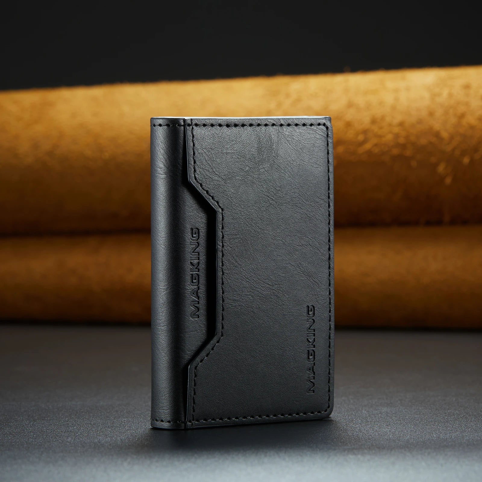 Black slim leather wallet with stitched front panel and brand logo.