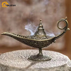 Ornate brass incense burner lamp with long spout and pedestal, smoke rising