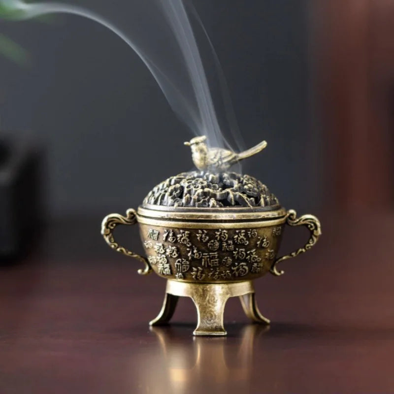 Copper lotus incense burner with ornate handles, standing feet, and bird-topped lid