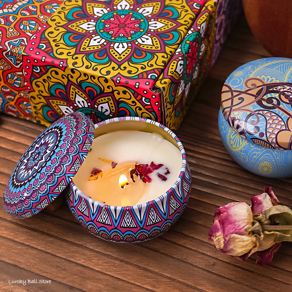 Lit scented candle in blue patterned tin with floral wax pieces inside