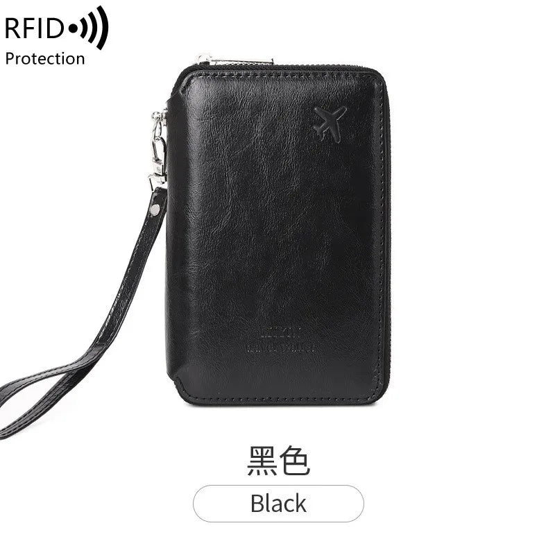 Midnight black RFID passport sleeve with wrist strap and top zipper; embossed minimalist emblem