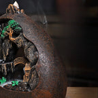 Close view of Misty Peaks backflow incense burner arch with smoke rising from basin