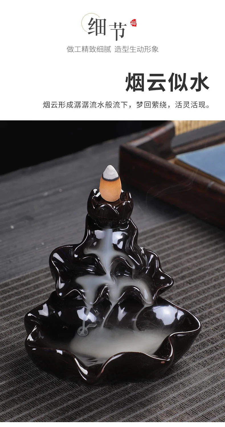 Black glossy backflow incense burner with cone incense above central pool and smoke