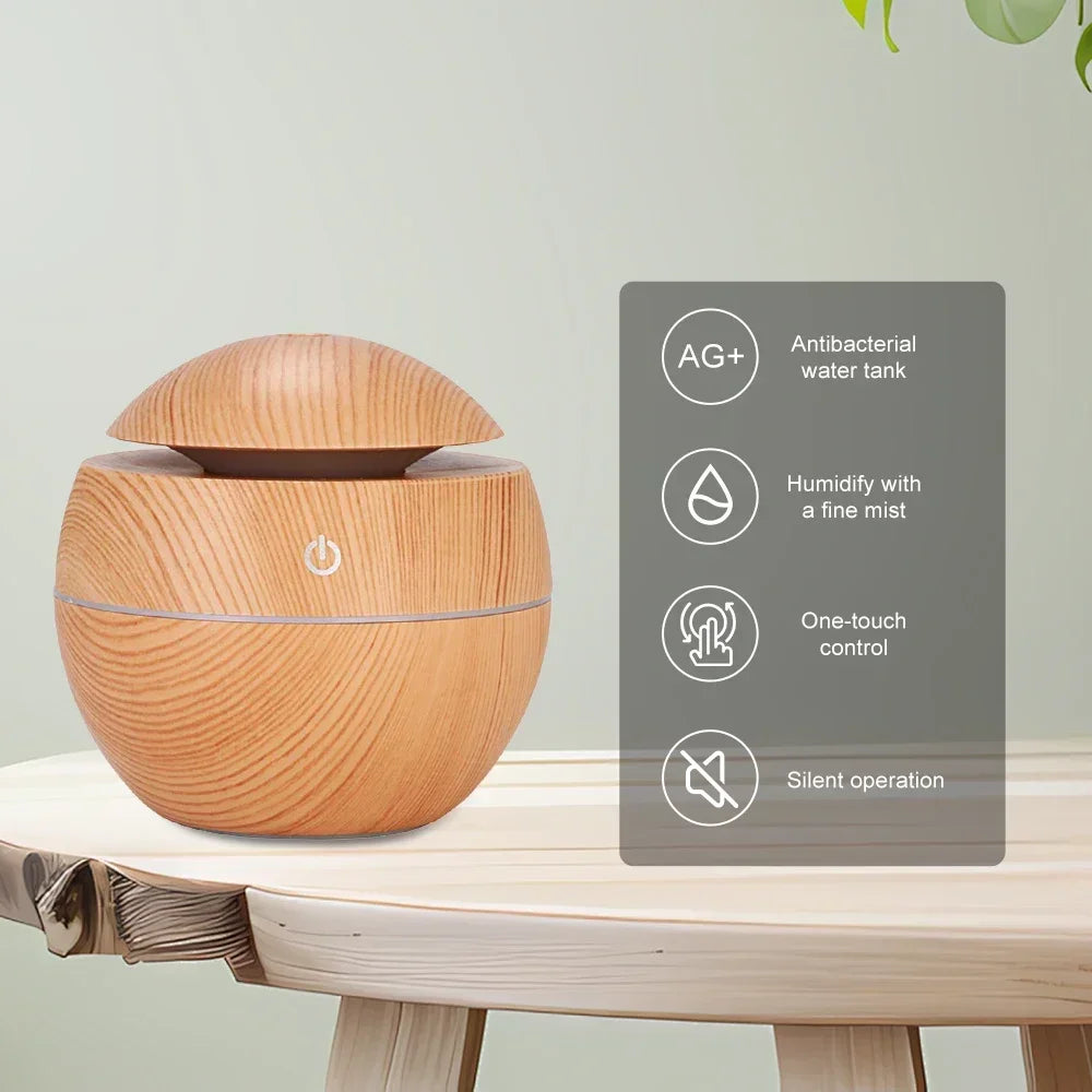 Wood-grain air humidifier diffuser on a shelf, round body with domed mist top and button.
