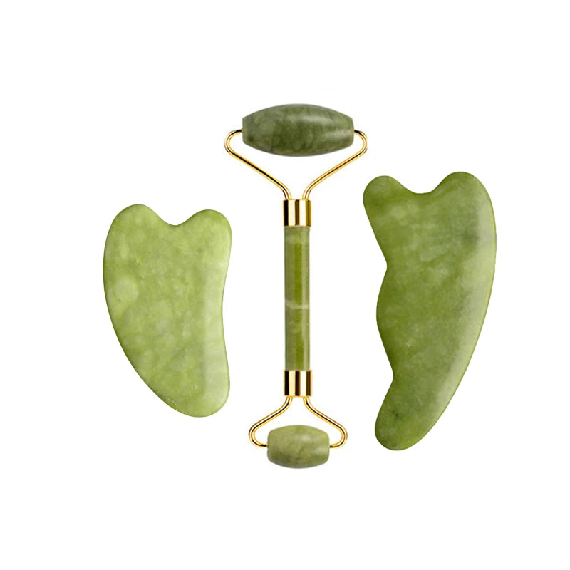 Green jade roller with small stone handle and two curved gua sha pieces, gold-toned metal