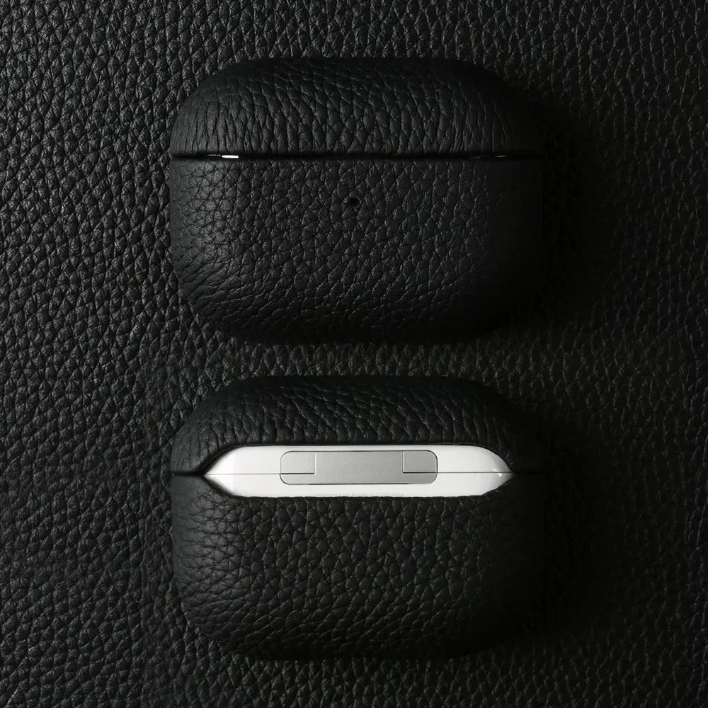 Obsidian black handmade leather AirPods case with AirPods exposed