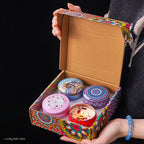 4-piece scented candle gift set in open box with colorful Arabian pattern lids