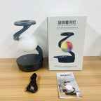 Wireless charging atmosphere lamp with dark base and white glowing light; cable and manual shown.