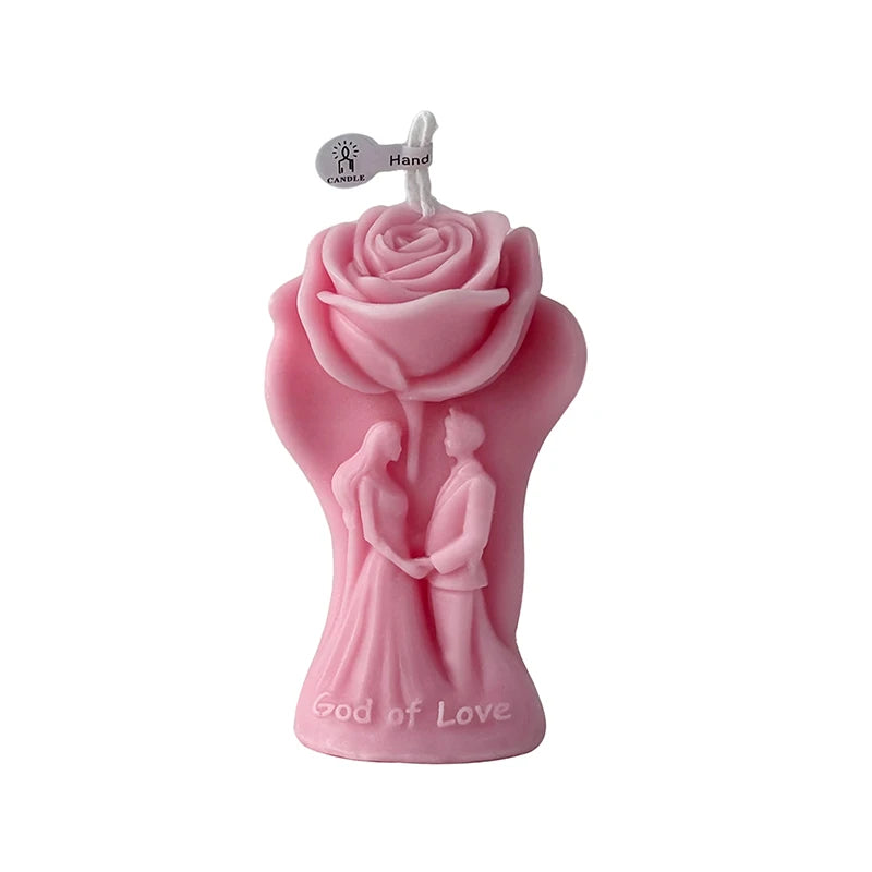 Pink rose-shaped candle figure with “God of Love” text and wick