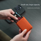 Alcantara MagSafe wallet card holder holding credit card, textured orange fabric