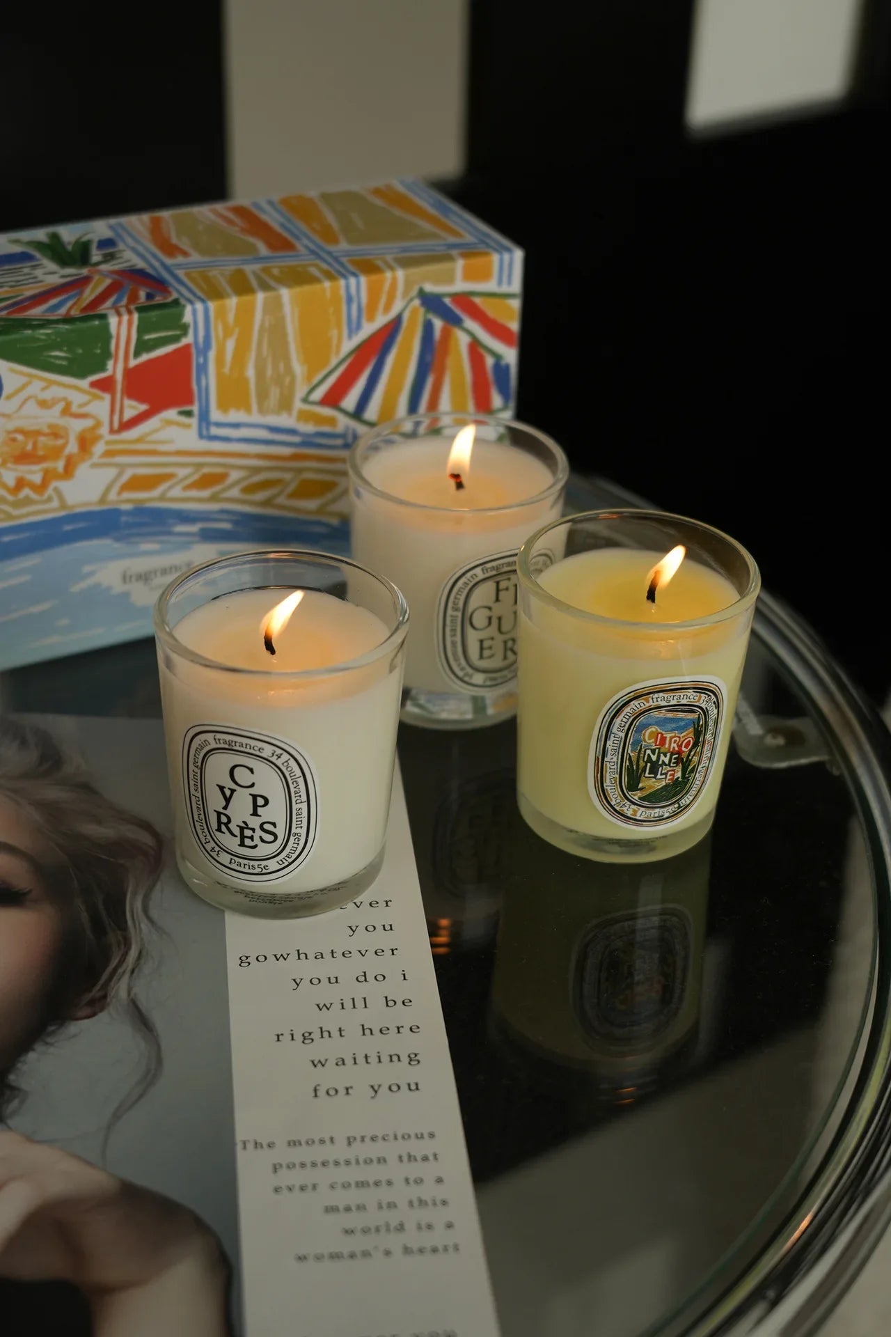 Lit French Botanical candle jars on a box, YP RÈS and pale yellow FIGUIER labels