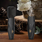 Black electric hair bakhoor diffuser with comb-style heat plate, producing visible vapor
