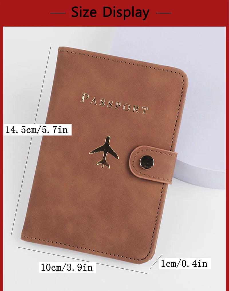 Cognac brown passport folio with airplane logo and snap button tab, stitched edges