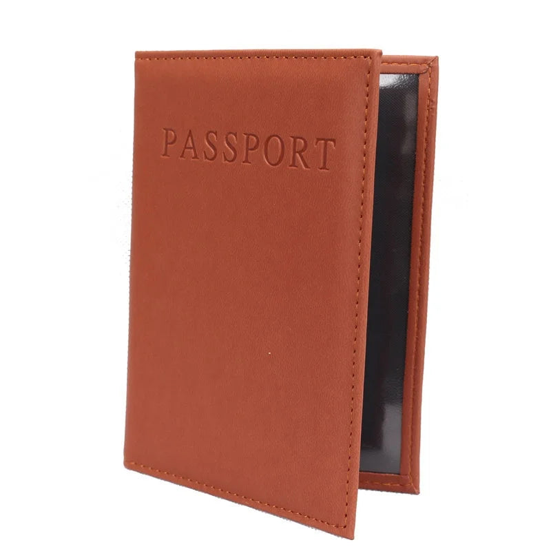 Cognac brown passport sleeve with embossed “PASSPORT” and dark inner lining