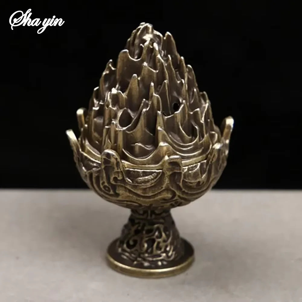 Close-up bronze mountain incense burner with detailed carved openings