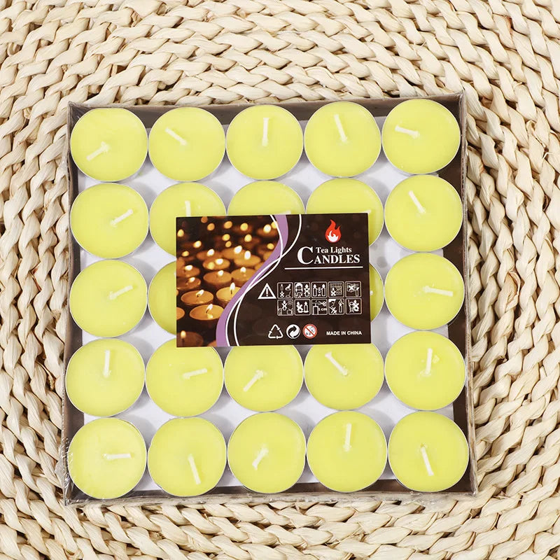 Yellow tea light candles in a tray, each with a white wick