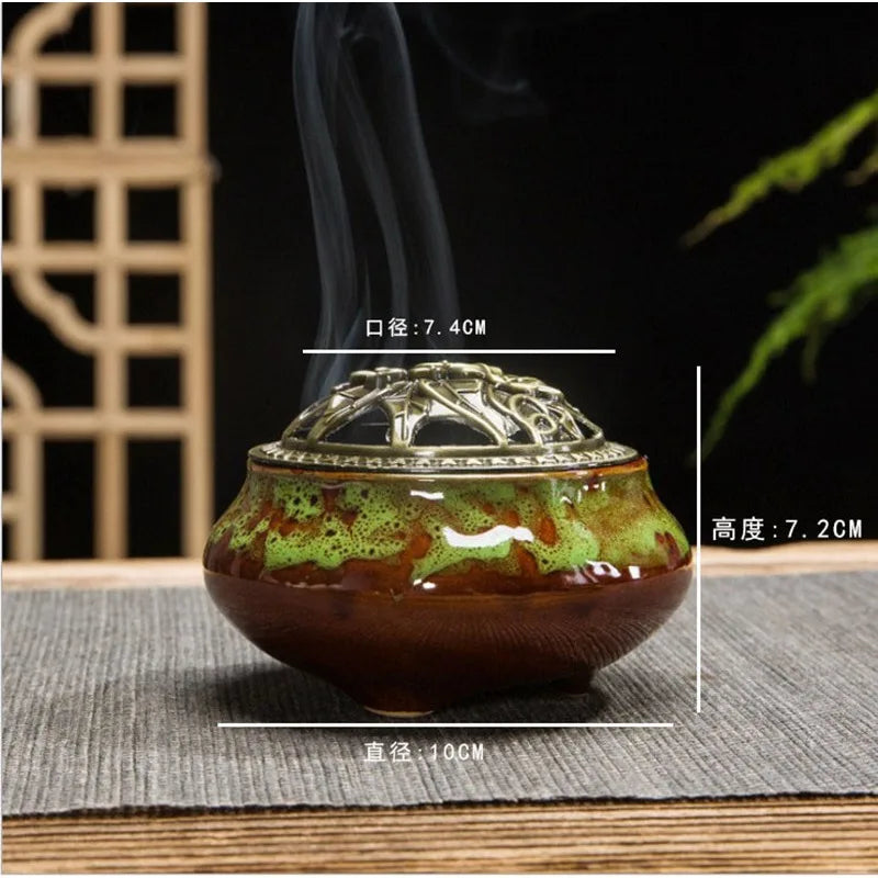 Ceramic incense burner with green-brown speckled glaze and ornate gold lid