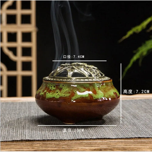 Ceramic incense burner with green-brown speckled glaze and ornate gold lid
