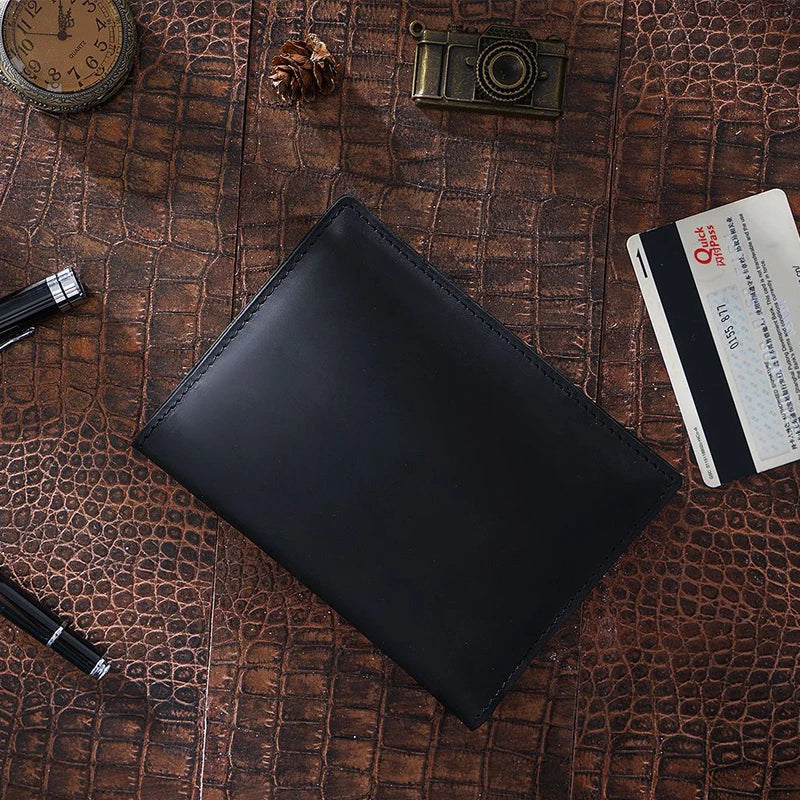 Obsidian black passport wallet with stitched edge and smooth front cover, top view