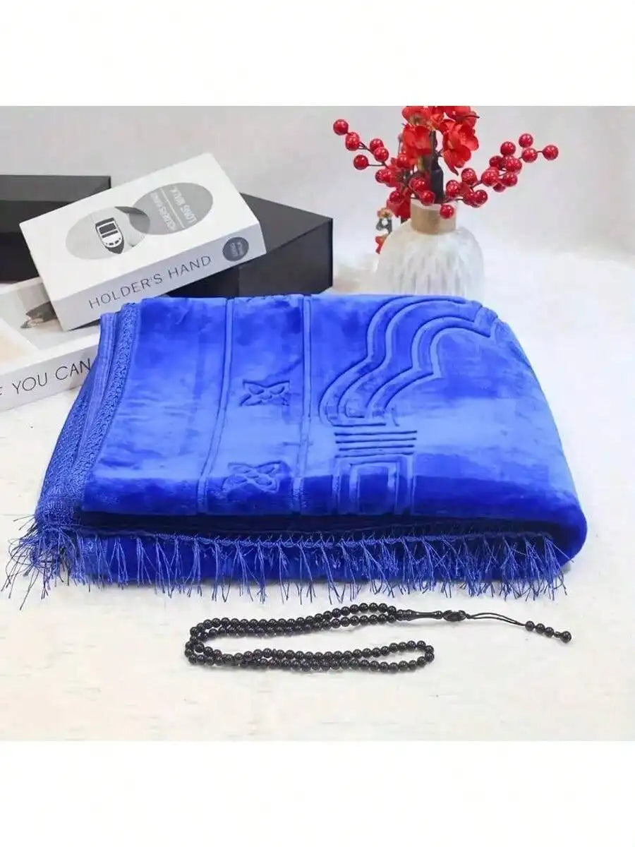 Blue velvet padded prayer rug with arched mihrab design and fringe, includes bead tasbih