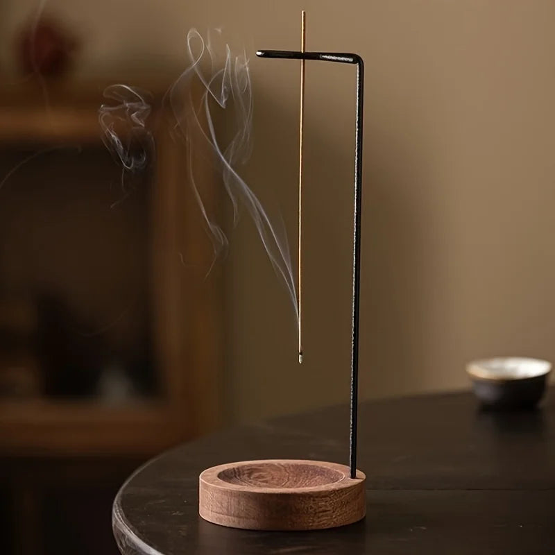 Walnut-black inverted incense holder with smoke above round wooden base