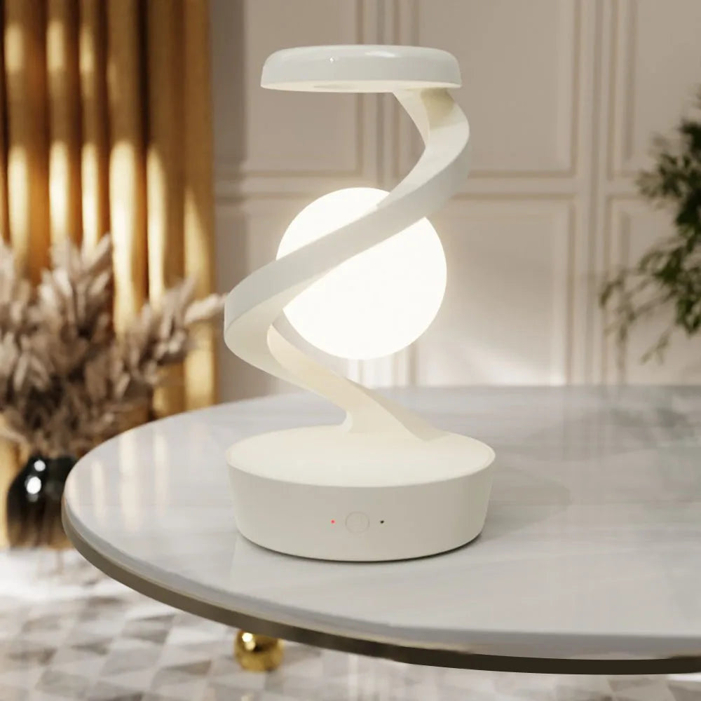 White wireless charging atmosphere lamp with glowing white orb and looping light ribbon