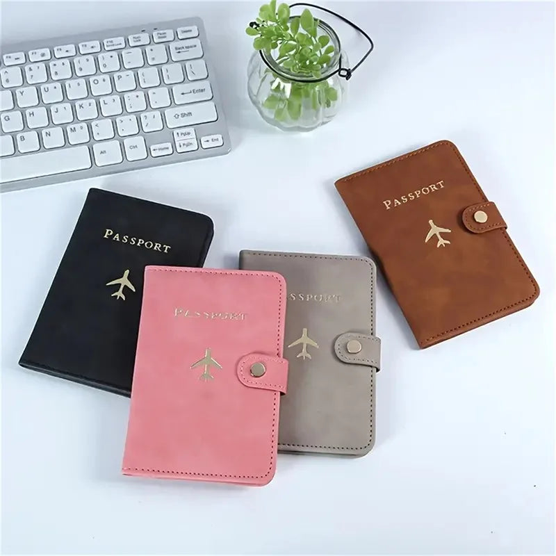 Midnight black vegan leather passport holder with “PASSPORT” text and airplane emblem