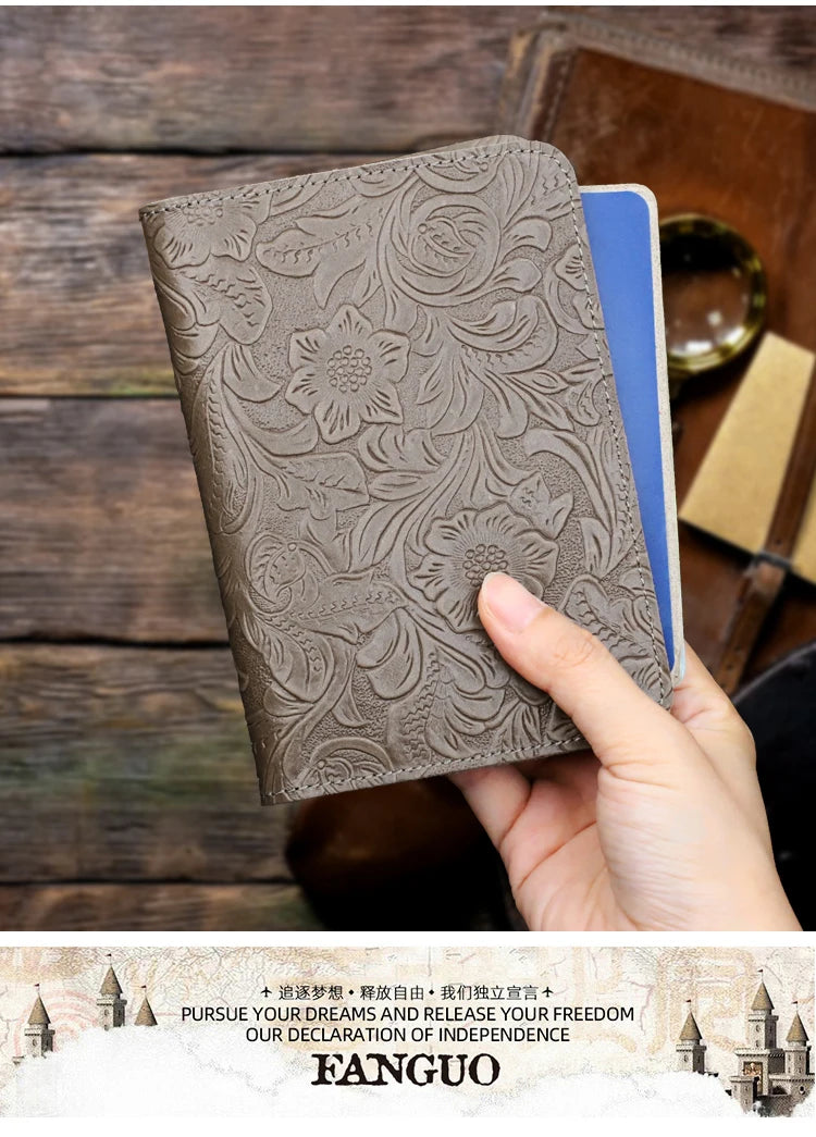 Slate grey embossed leather travel folio with floral relief, hand holding