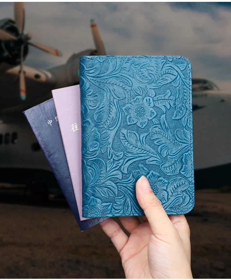 Midnight Blue leather travel folio held in hand with embossed floral texture