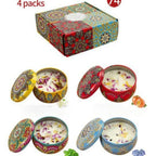 Four scented candle tins with lids open inside a decorative gift box