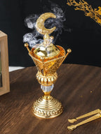 Brushed gold mabkhara with smoke rising from the charcoal holder
