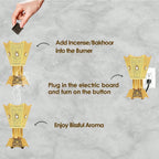 Golden electric incense burner with bakhoor inserted and smoke trail
