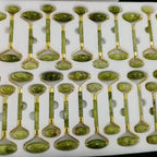 Green jade glow rollers arranged in rows with gold-tone metal heads