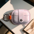 Light pink PU AirPods cover with orange strap, silver key ring, and snap button