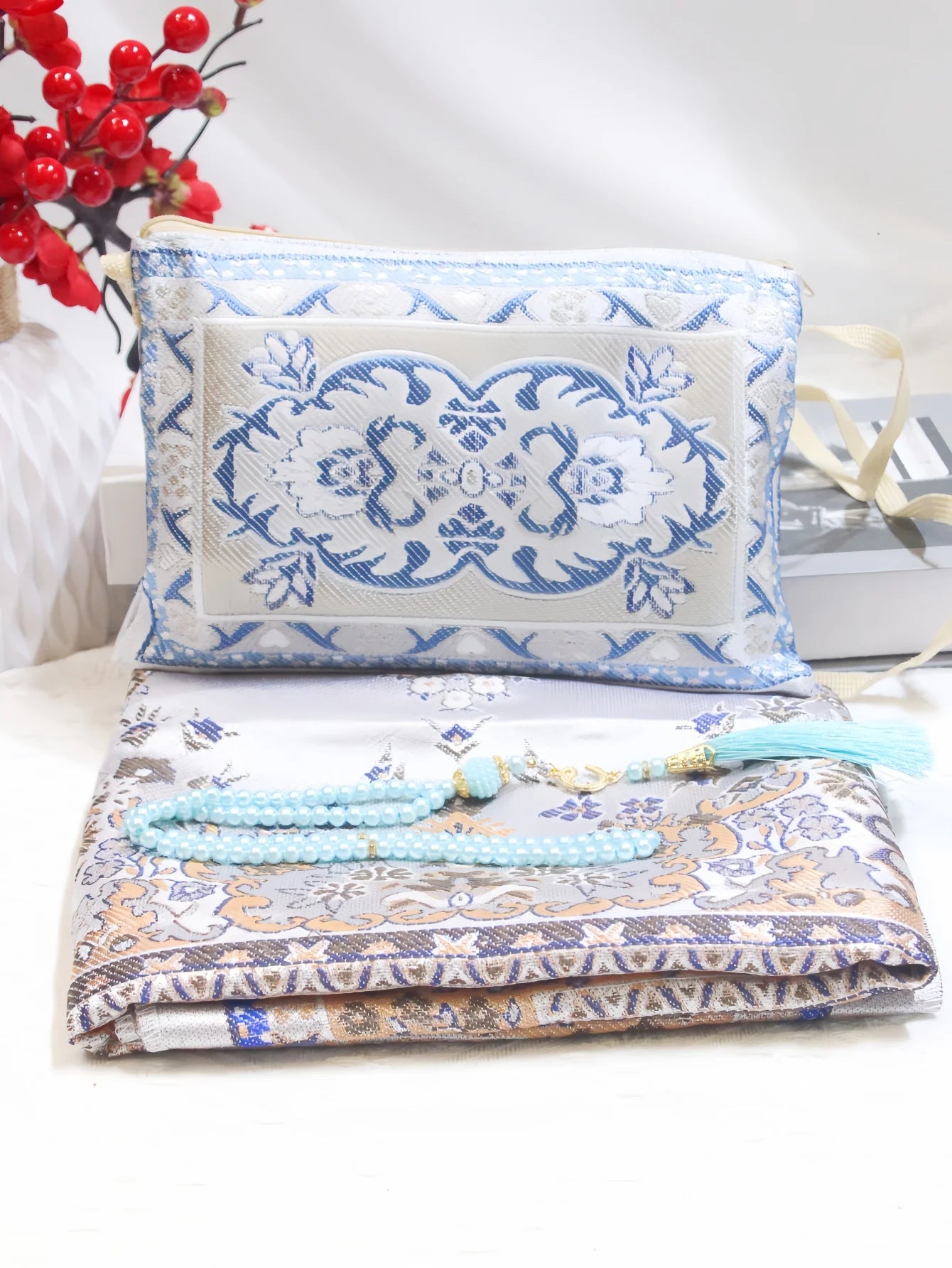 Prayer rug gift set with blue floral pouch, patterned mat, and light blue bead strand