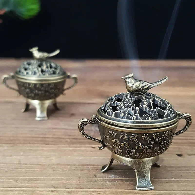 Copper lotus incense burner with bird-topped lid on tripod-like feet, embossed body