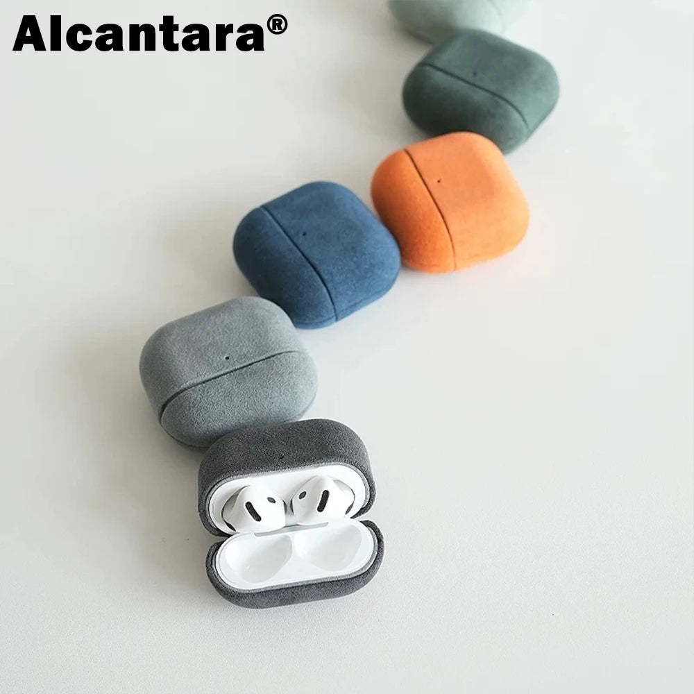 Dark gray Alcantara AirPods case with white AirPods inside; rounded suede texture