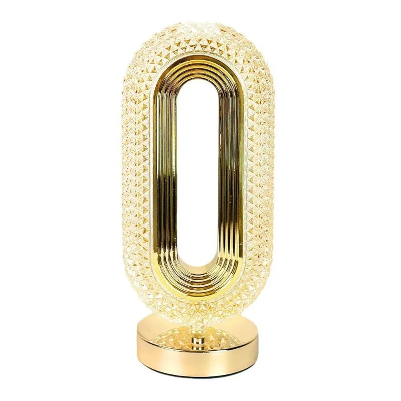 Close-up: pearl white oval lamp body with gold base and inner gold ring details