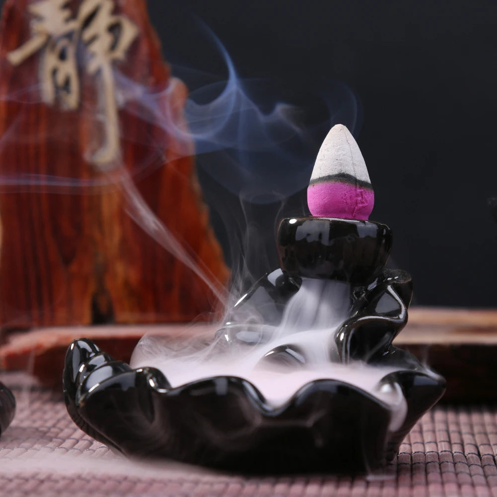 Backflow incense cone refill set with lit purple cone releasing smoke
