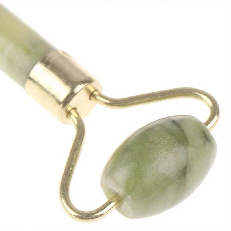 Close-up of Classic Jade gua sha roller end with oval stone and gold loop