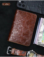 Leather travel folio in cognac brown with embossed floral scroll pattern