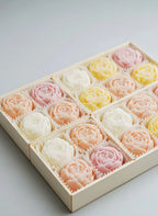 Rose gift set box with pastel flower-shaped soy candles: pink, yellow, and white