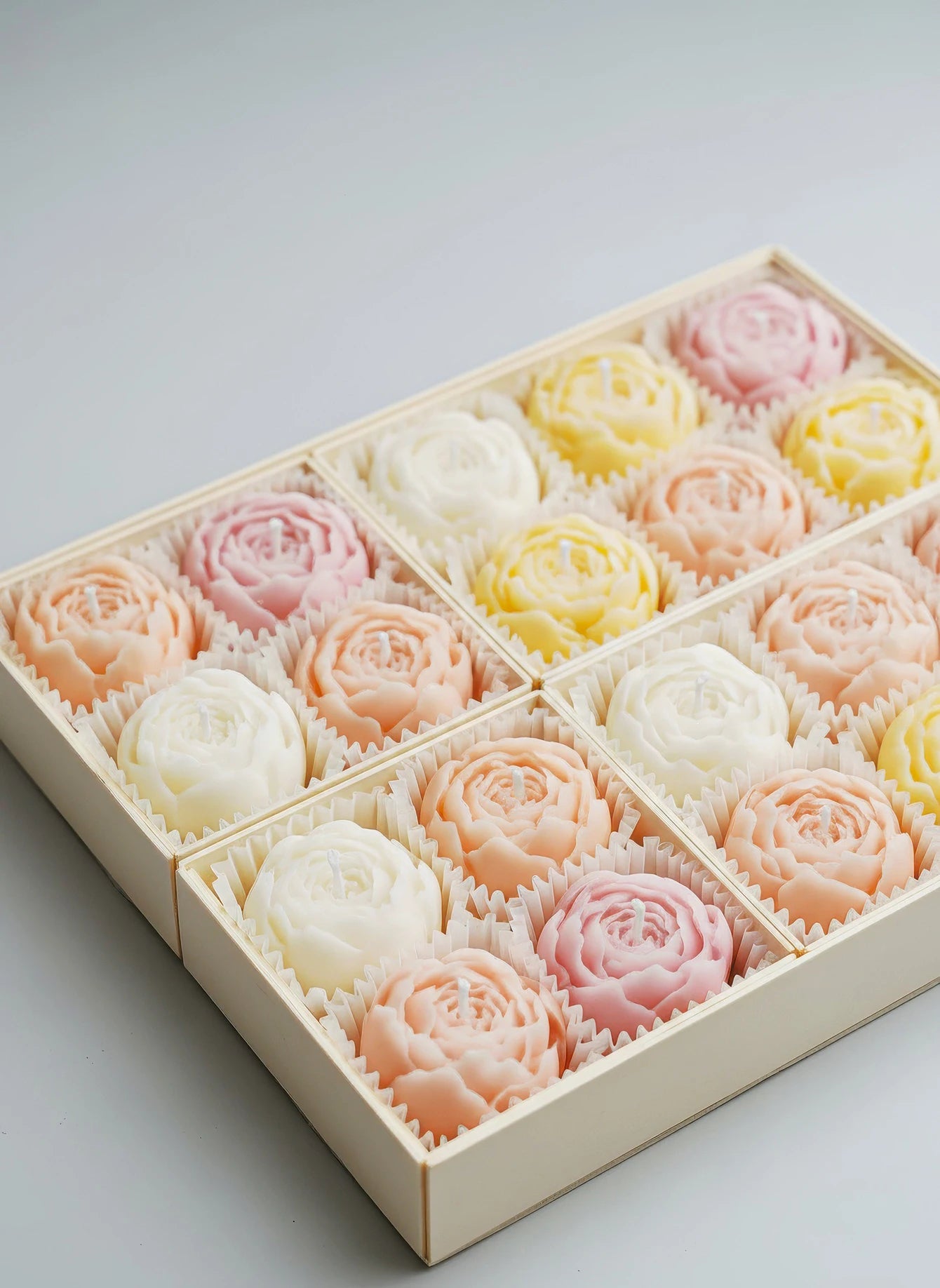 Rose gift set box with pastel flower-shaped soy candles: pink, yellow, and white