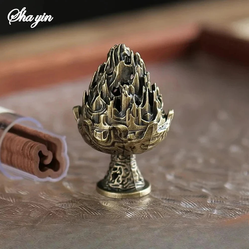Bronze mountain incense burner on round base with smoke curling up
