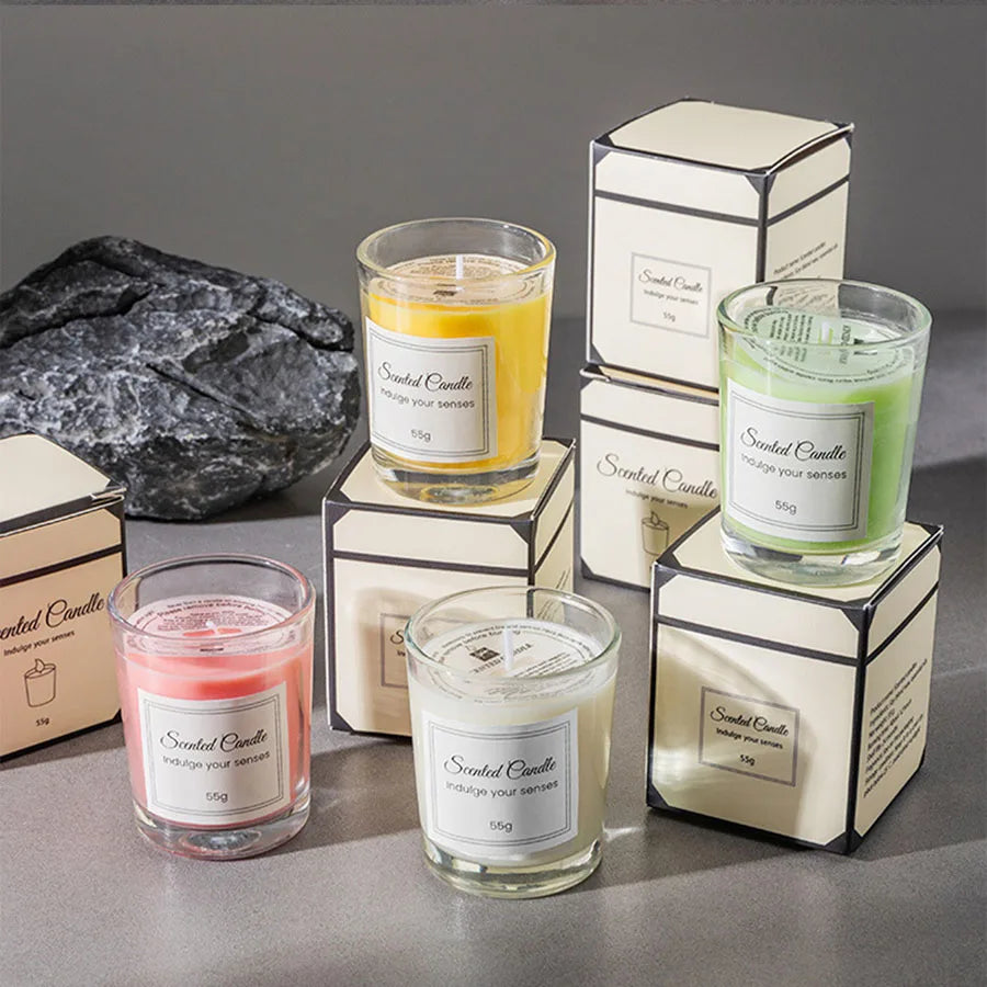 Assorted colored glass scented candles with gift boxes and lit wicks