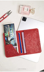 Red embossed leather travel folio with card holders and a clear ID card window.