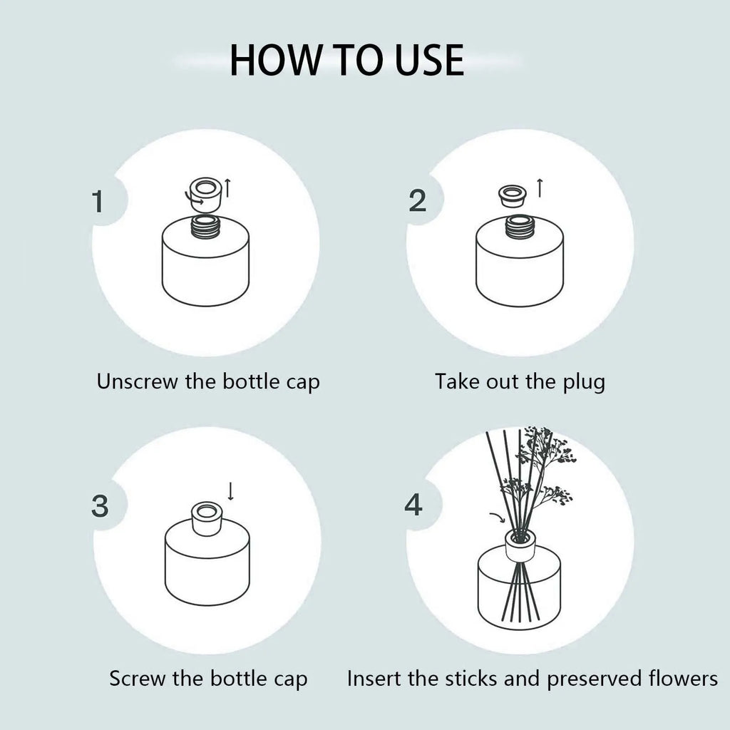 Reed diffuser bottle with black reeds and white rose flower in the glass