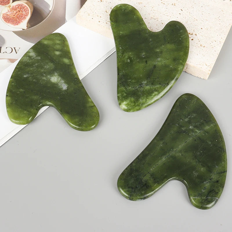 Three heart-shaped jade gua sha tools, green polished Xiuyan jade for facial massage